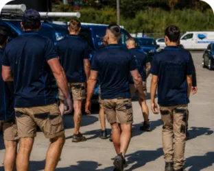 Plumbers walking to their service vans on a Homebush West job